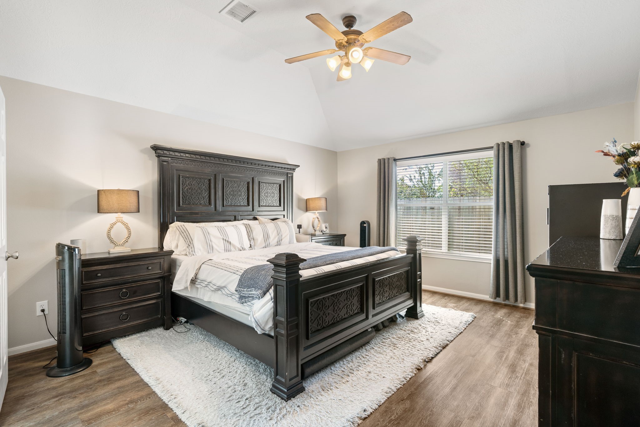 20903 Manon Lane Spring, TX 77388 - Photo 18 of 31 a spacious bedroom with a bed and a chandelier