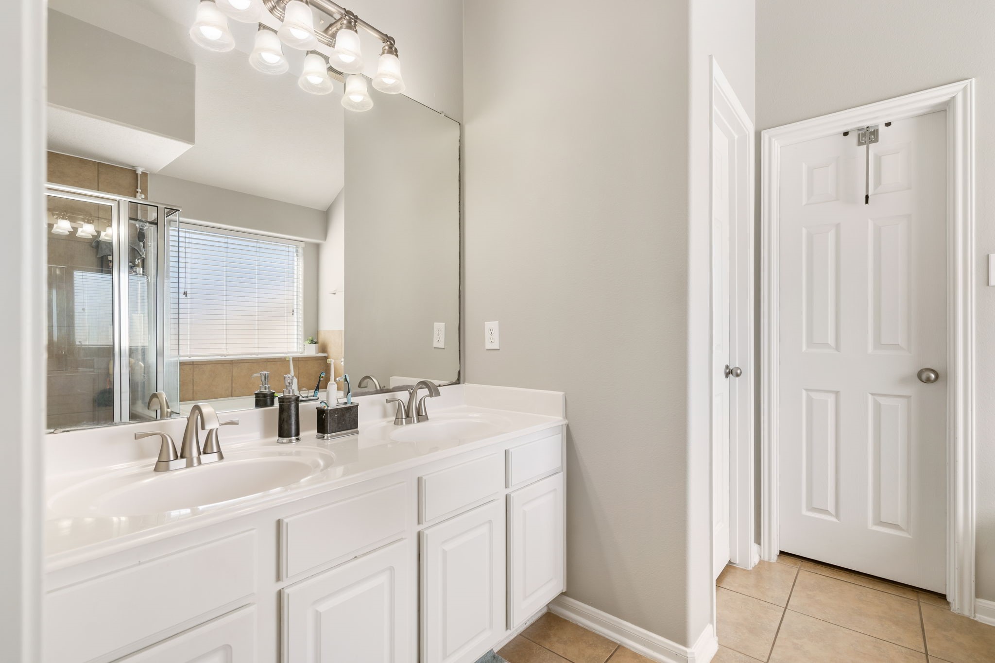 20903 Manon Lane Spring, TX 77388 - Photo 21 of 31 a bathroom with a sink double vanity and a mirror