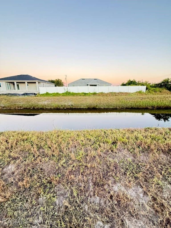 1102 Adeline Avenue Lehigh Acres, FL 33971 - Photo 4 of 9 a view of lake with mountain in the background