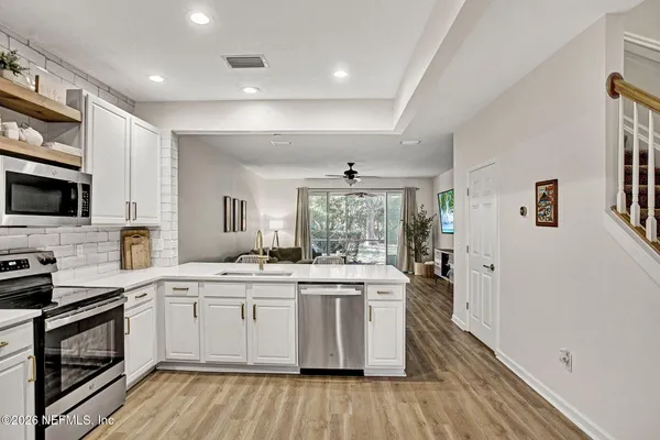 a kitchen with a sink stove and cabinets