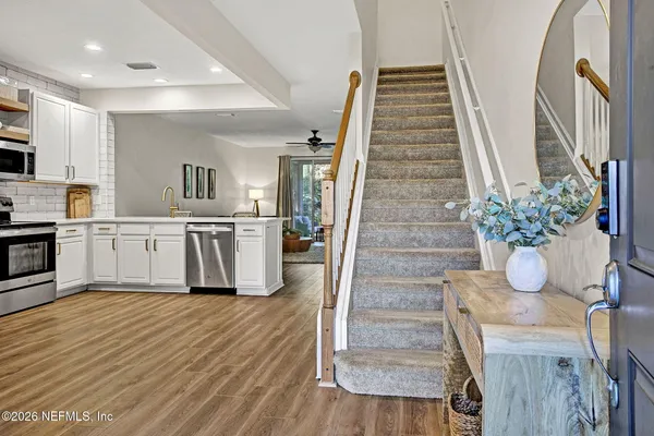 a kitchen with cabinets and wooden floor