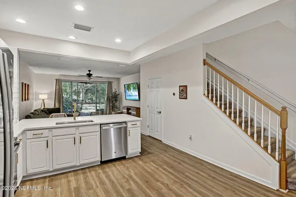 a kitchen with a sink stove and cabinets