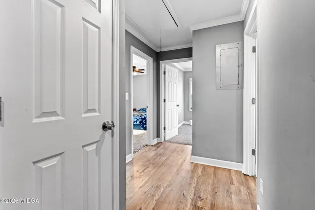 a view of a hallway with wooden floor and entryway
