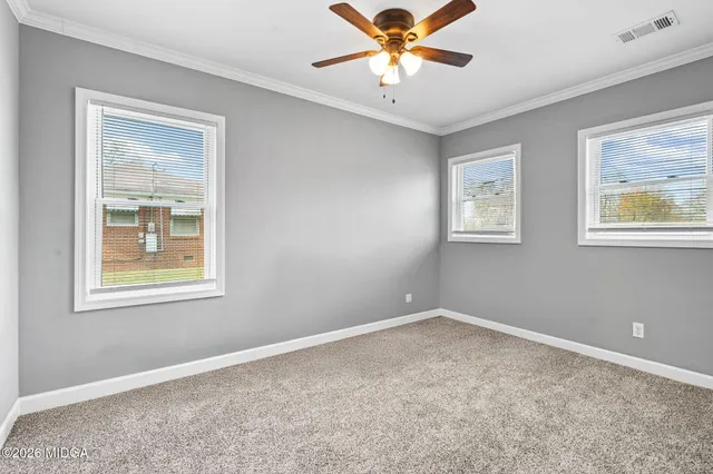 a view of an empty room with a window