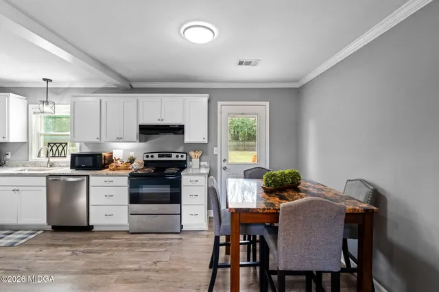 a kitchen with a stove a sink and a refrigerator