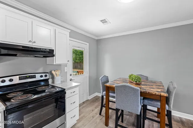 a kitchen with a table and chairs in it