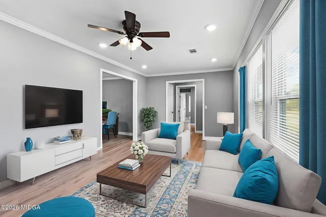 a living room with furniture and a flat screen tv