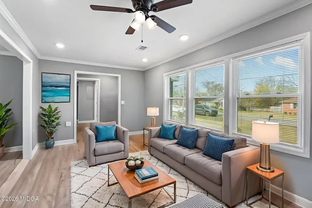 a living room with furniture and a large window