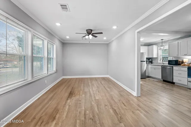 a view of a kitchen with a sink and wooden floor