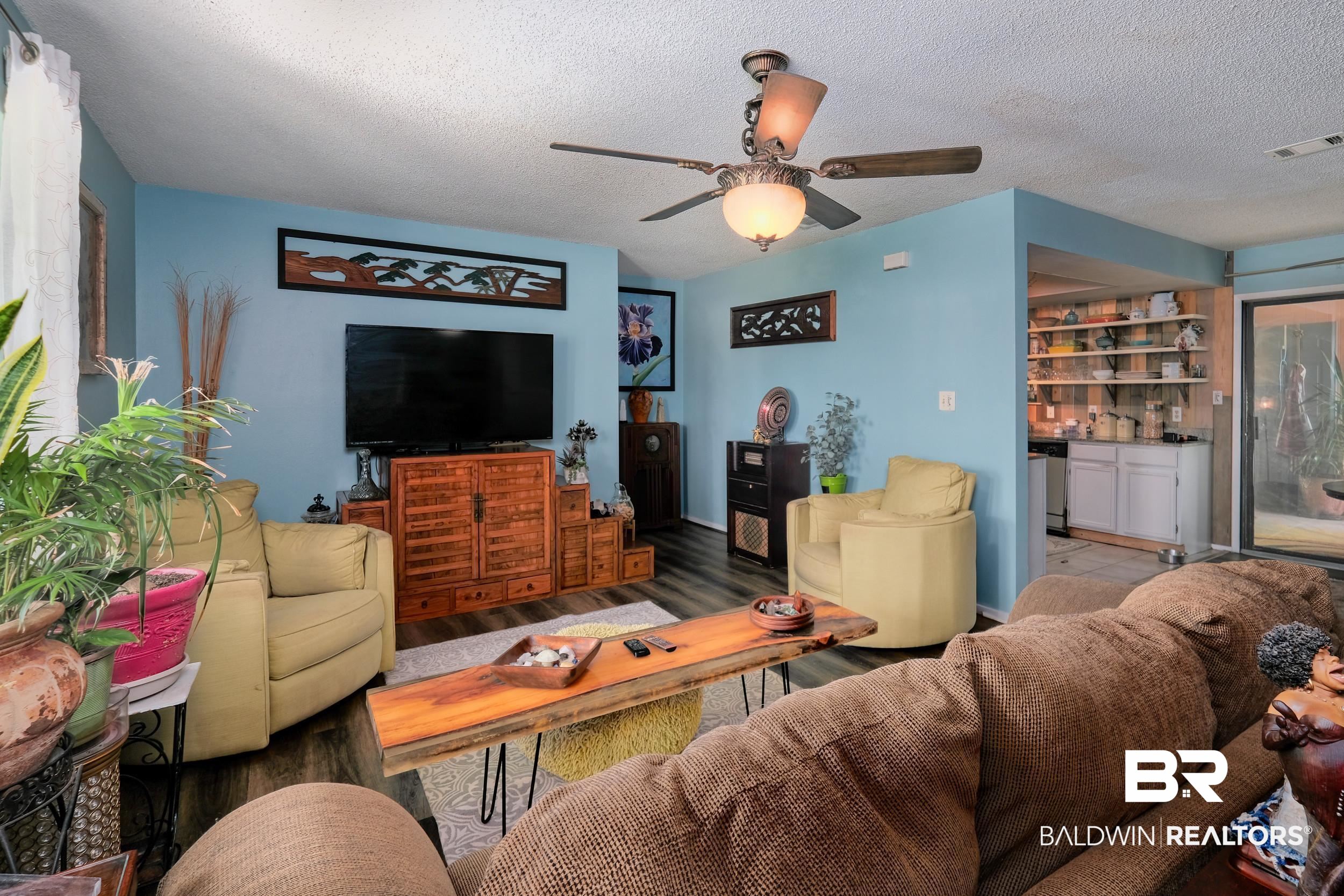 504 Ariel Avenue Foley, AL 36535 - Photo 11 of 33 Living room with wood-type flooring, a textured ceiling, and ceiling fan