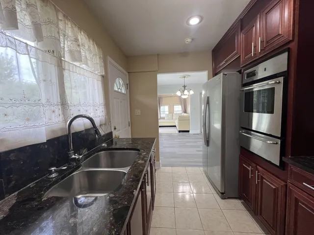 a kitchen with a sink cabinets and stainless steel appliances