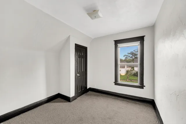 an empty room with windows and closet