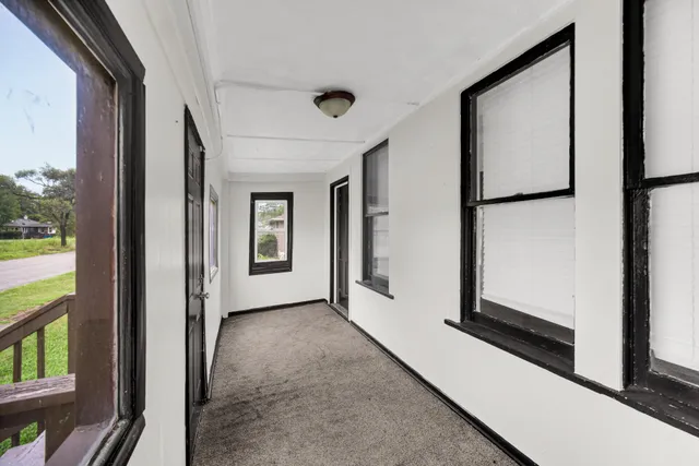 a view of a hallway with windows and entryway
