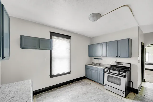a kitchen with stainless steel appliances a stove and a microwave