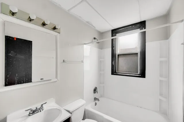 a bathroom with a bathtub and a sink