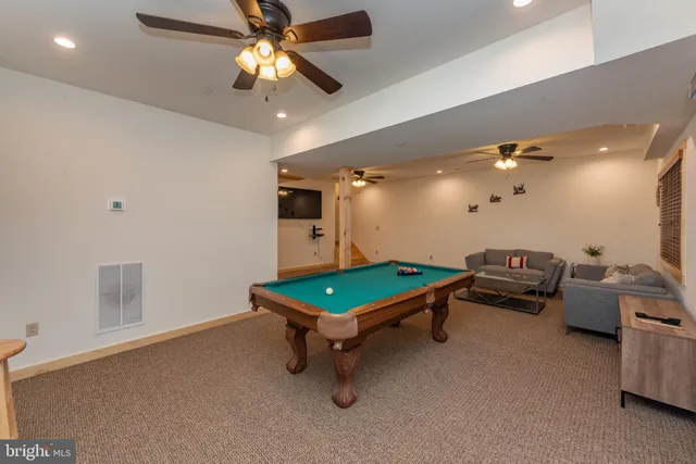 a room with furniture and pool table