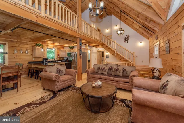 a living room with furniture and a chandelier