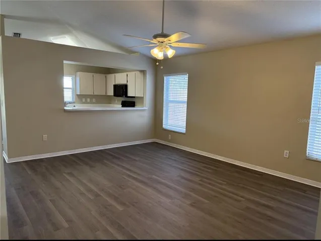 a view of a room with wooden floor and a window