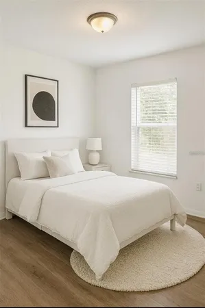 a bedroom with a bed and a painting