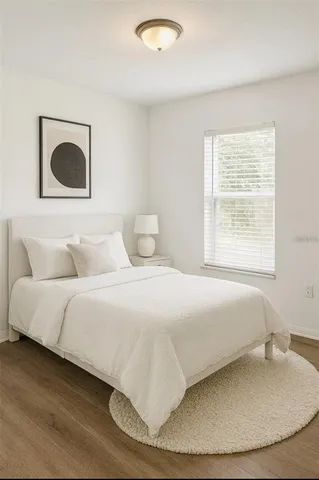 a bedroom with a bed and a painting