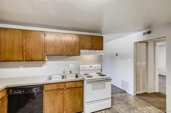 a kitchen with a sink cabinets and appliances