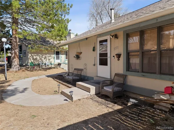 a backyard of a house with outdoor seating