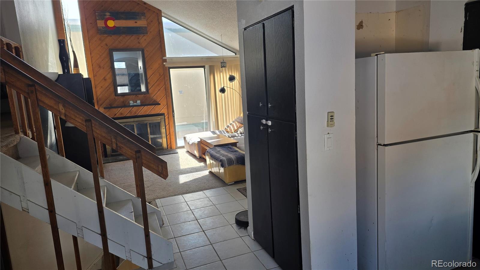 3771 South Danube Circle Aurora, CO 80013 - Photo 11 of 25 a view of a hallway with wooden floor and staircase