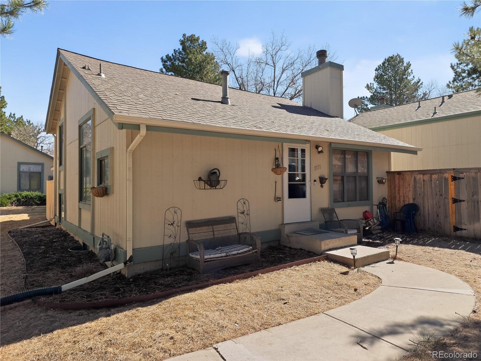3771 South Danube Circle Aurora, CO 80013 - Photo 2 of 25 a front view of a house with a yard