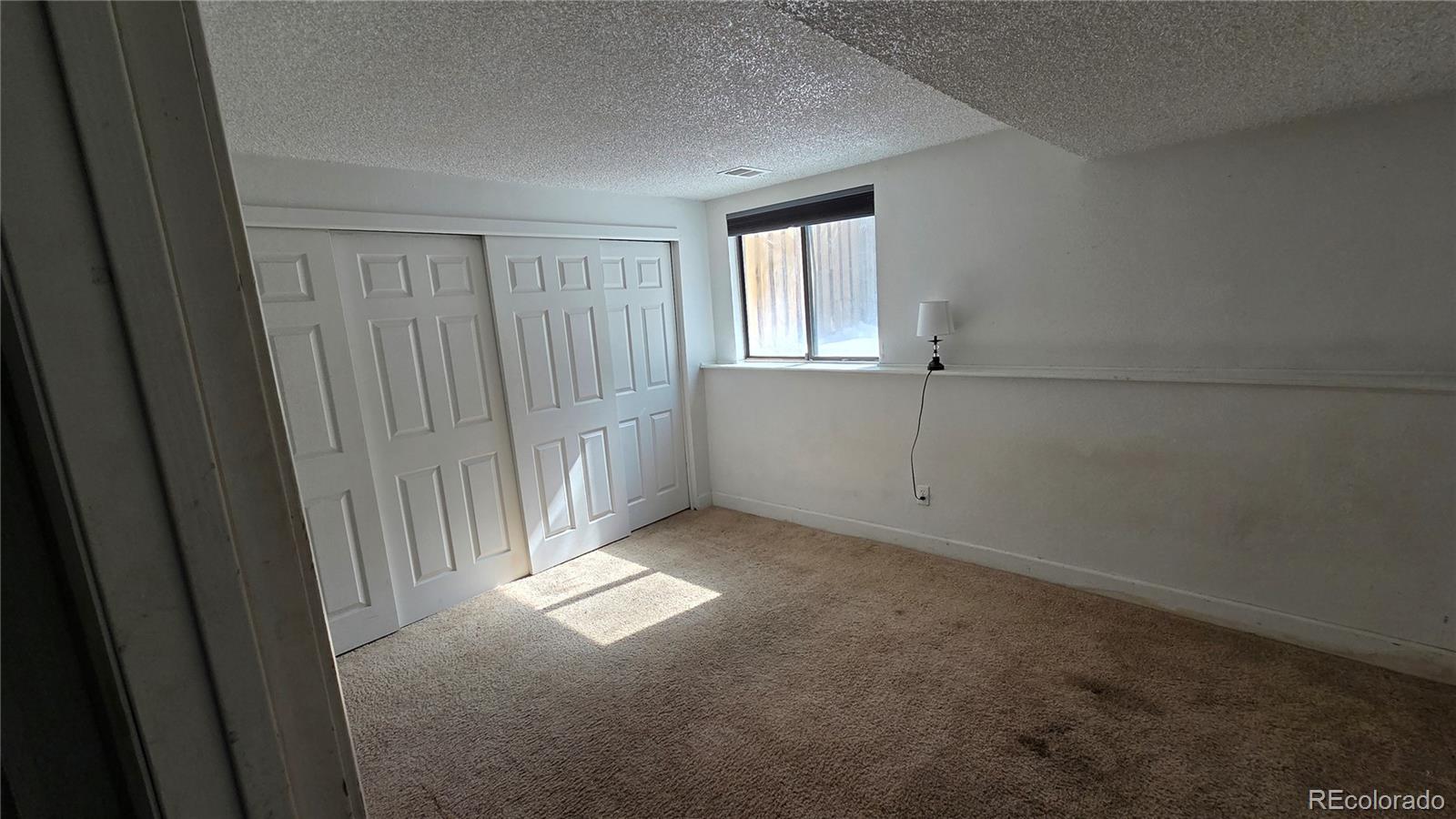 3771 South Danube Circle Aurora, CO 80013 - Photo 21 of 25 a view of an empty room with a window