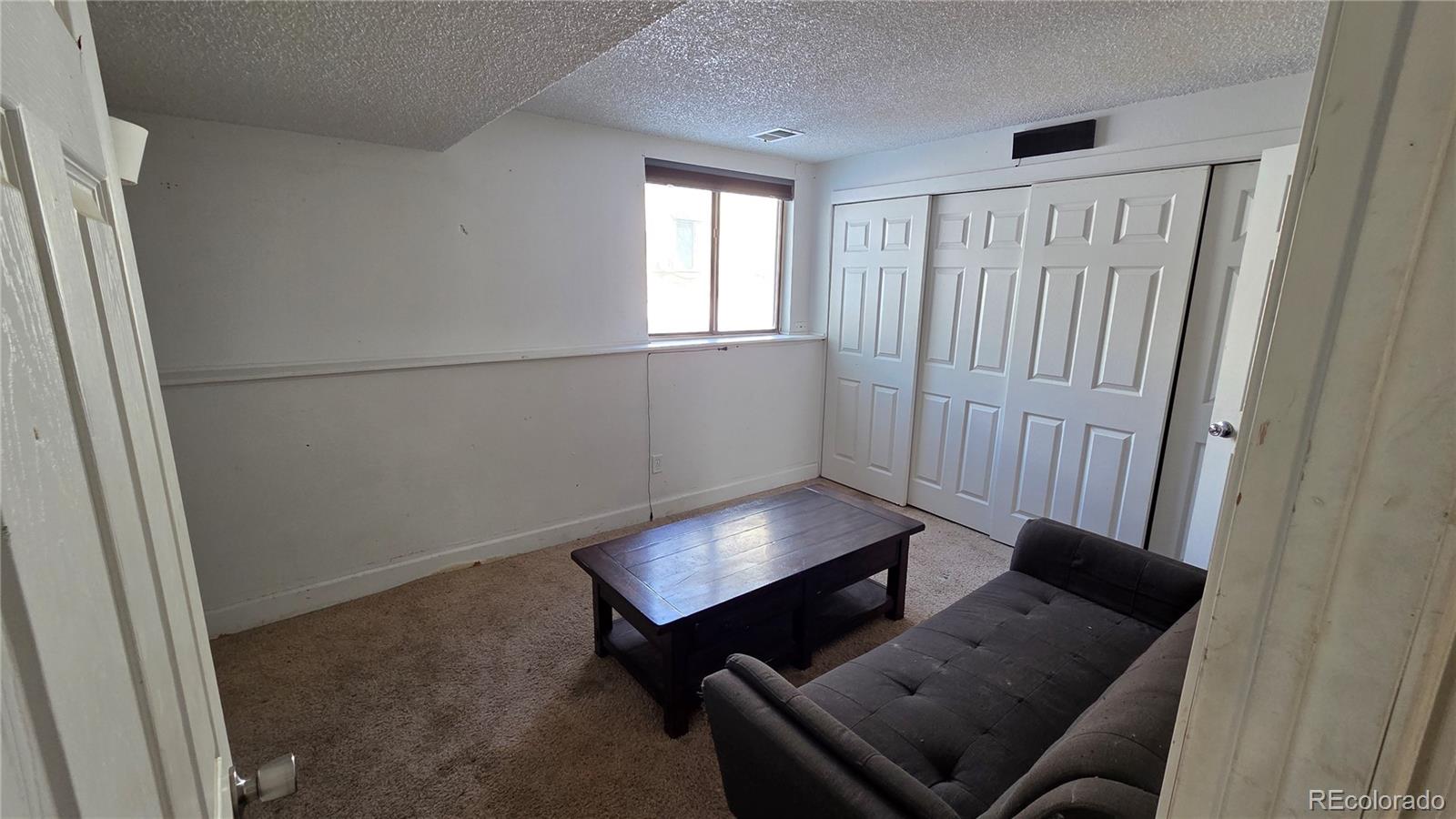 3771 South Danube Circle Aurora, CO 80013 - Photo 22 of 25 a living room with furniture and a window