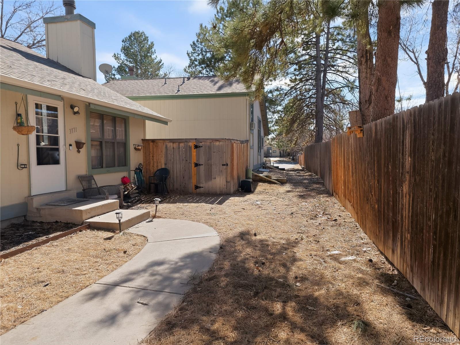 3771 South Danube Circle Aurora, CO 80013 - Photo 3 of 25 a view of a backyard with a barbeque grill and wooden fence