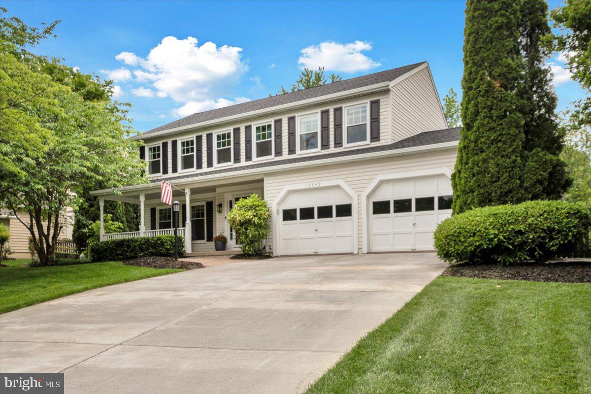 a front view of a house with a garden and plants