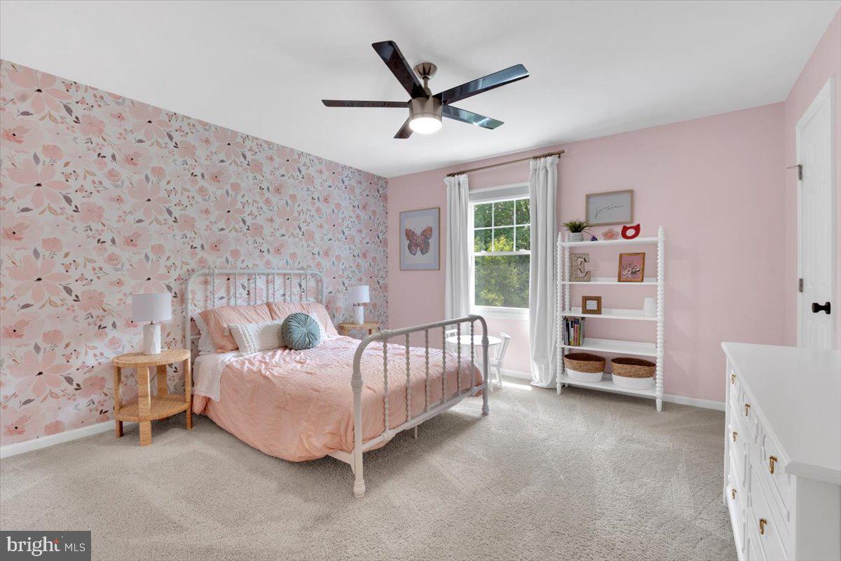 12649 Thunder Chase Drive Reston, VA 20191 - Photo 25 of 53 a bedroom with a bed and a chandelier