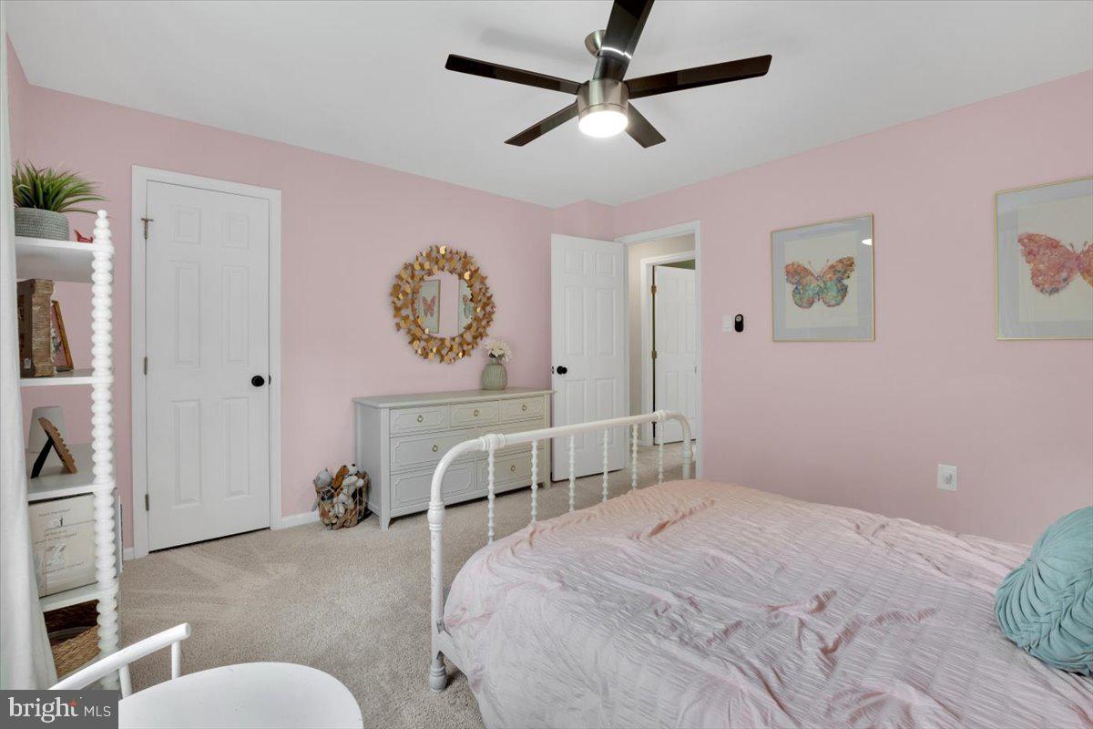 12649 Thunder Chase Drive Reston, VA 20191 - Photo 26 of 53 a bedroom with a large bed and a chandelier
