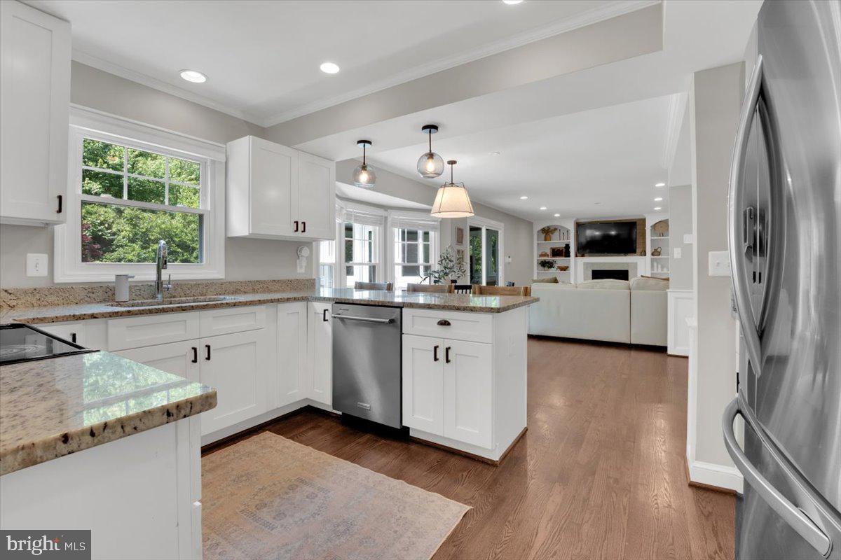 12649 Thunder Chase Drive Reston, VA 20191 - Photo 3 of 53 a kitchen with stainless steel appliances granite countertop a sink stove and refrigerator