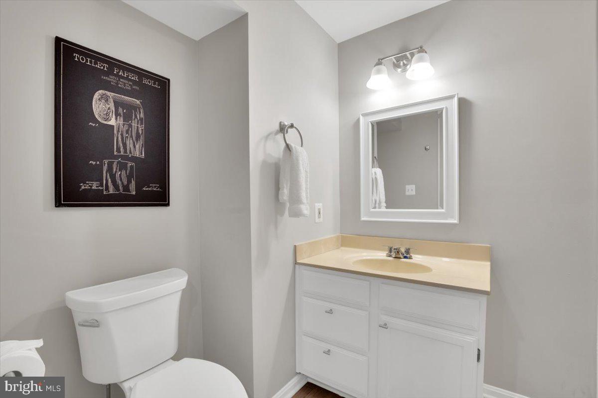 12649 Thunder Chase Drive Reston, VA 20191 - Photo 35 of 53 a bathroom with a toilet a sink and mirror