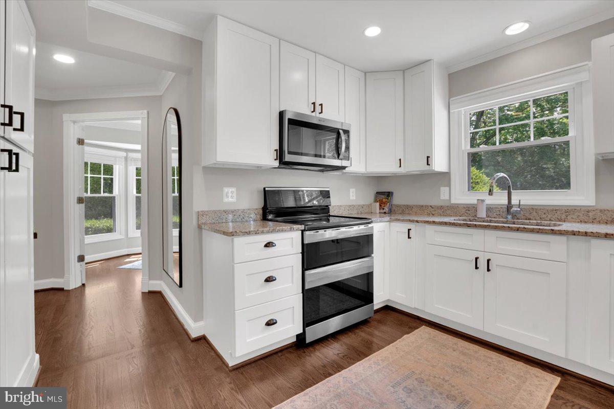 12649 Thunder Chase Drive Reston, VA 20191 - Photo 4 of 53 a kitchen with stainless steel appliances granite countertop a stove a sink and a refrigerator