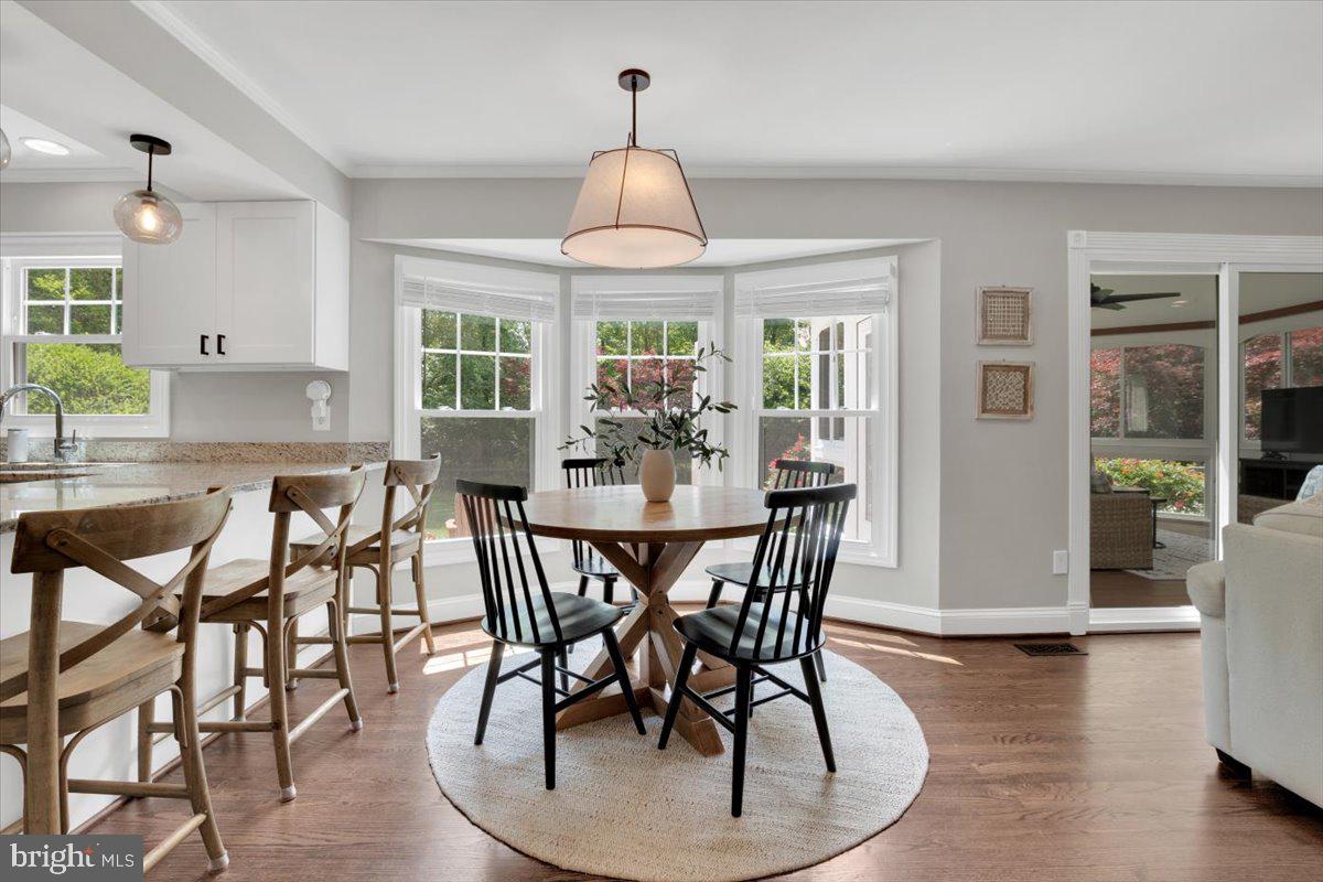 12649 Thunder Chase Drive Reston, VA 20191 - Photo 9 of 53 a dining room with furniture a chandelier and wooden floor