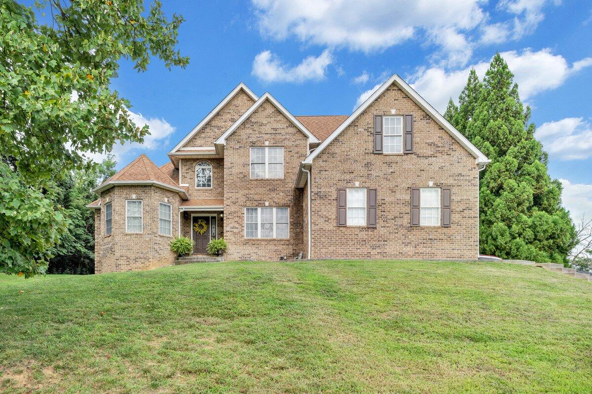 a front view of a house with a yard