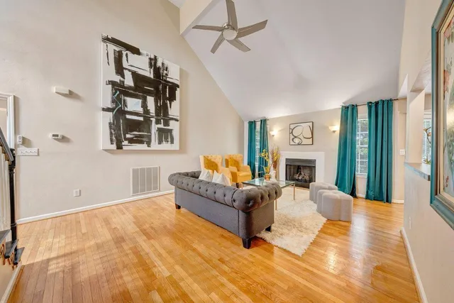 a living room with furniture a fireplace and a flat screen tv
