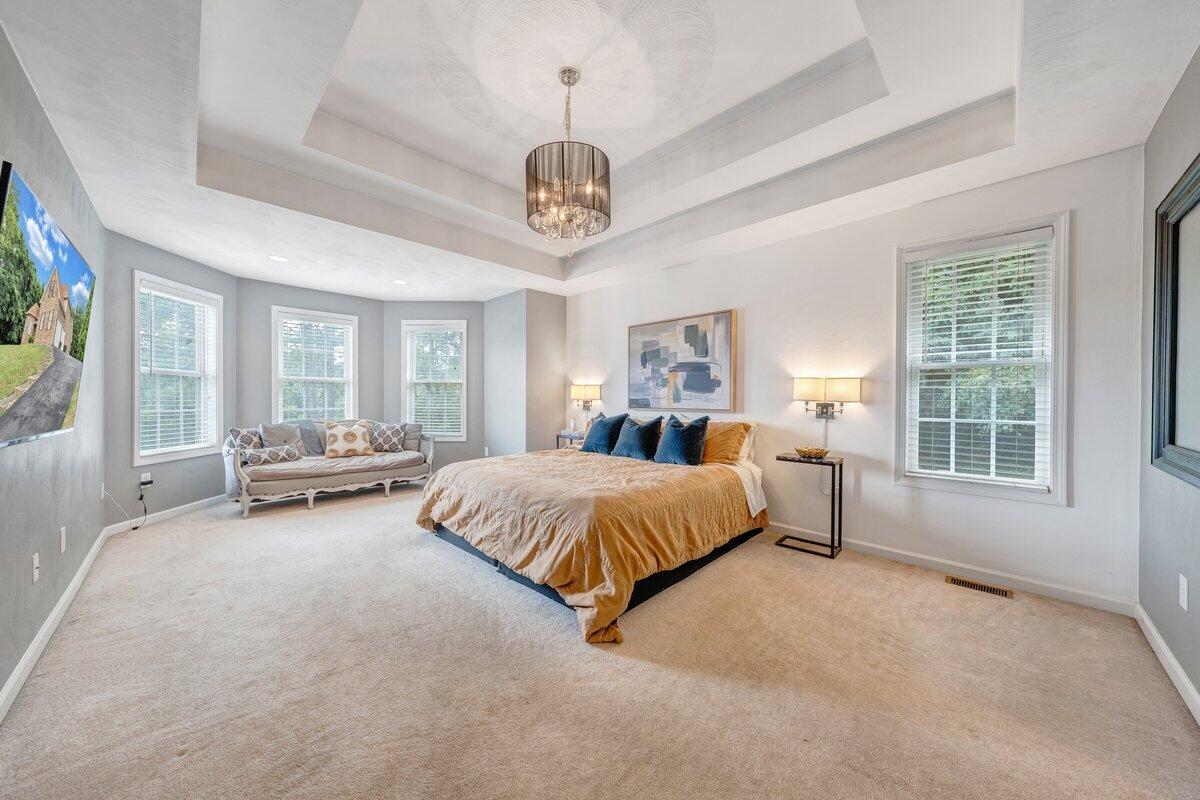 3770 Laurel Ridge Road Northwest Roanoke, VA 24019 - Photo 26 of 55 a spacious bedroom with a large bed and a chandelier