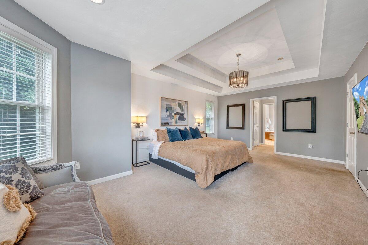 3770 Laurel Ridge Road Northwest Roanoke, VA 24019 - Photo 28 of 55 a bedroom with a large bed and a chandelier