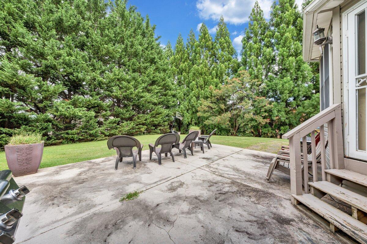 3770 Laurel Ridge Road Northwest Roanoke, VA 24019 - Photo 47 of 55 a view of a patio with table and chairs potted plants with wooden fence