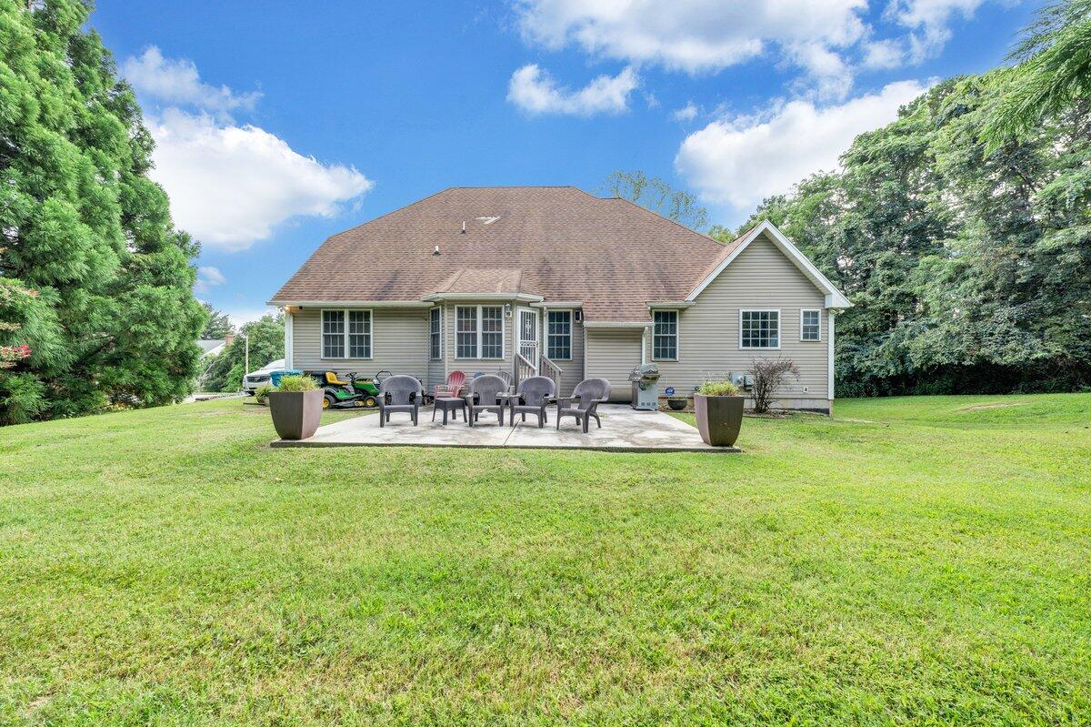 3770 Laurel Ridge Road Northwest Roanoke, VA 24019 - Photo 48 of 55 a view of a patio with table and chairs under an umbrella