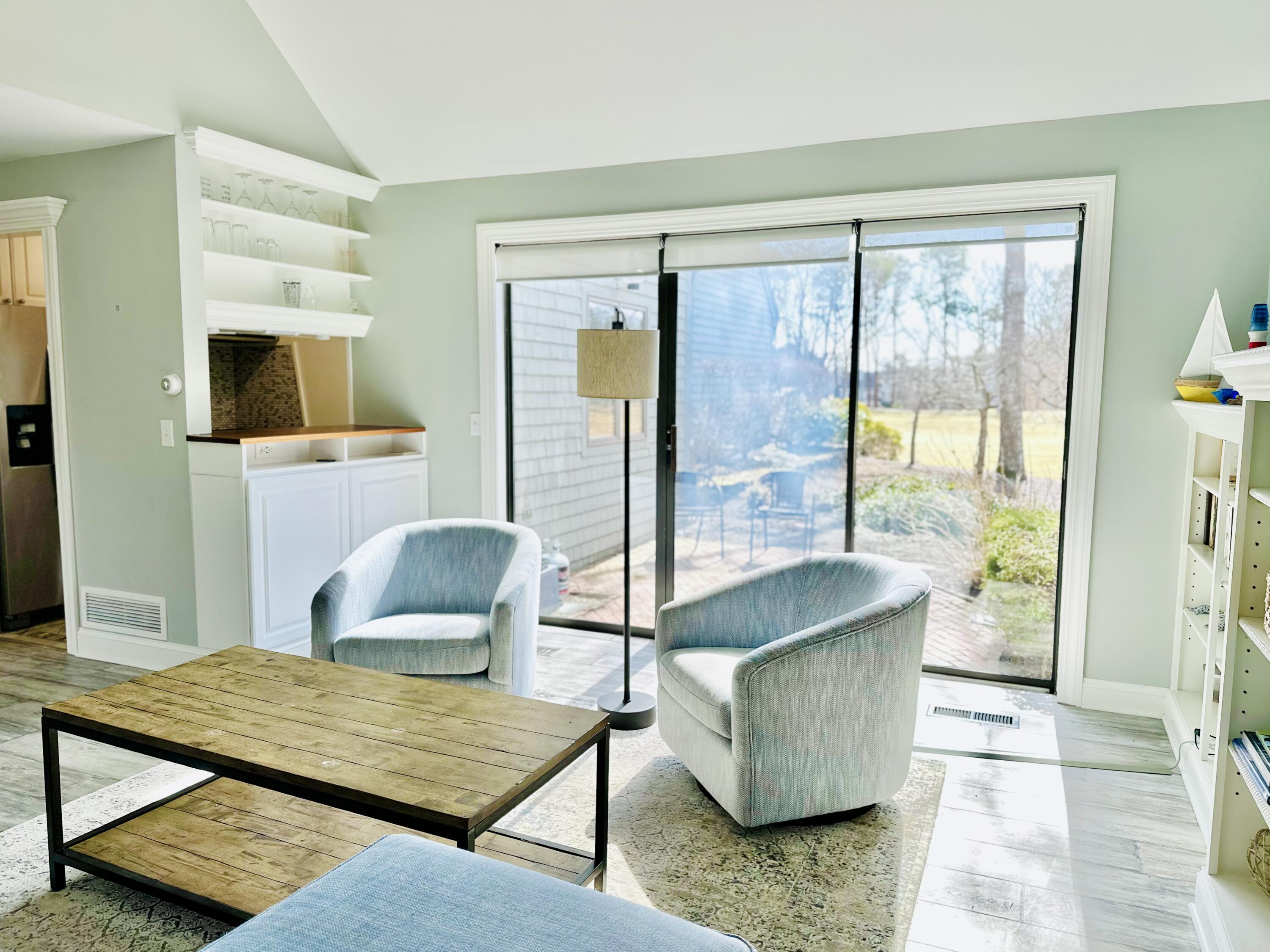 22 Mid-Iron Way, Unit 7517 Mashpee, MA 02649 - Photo 11 of 47 a bedroom with furniture and large windows