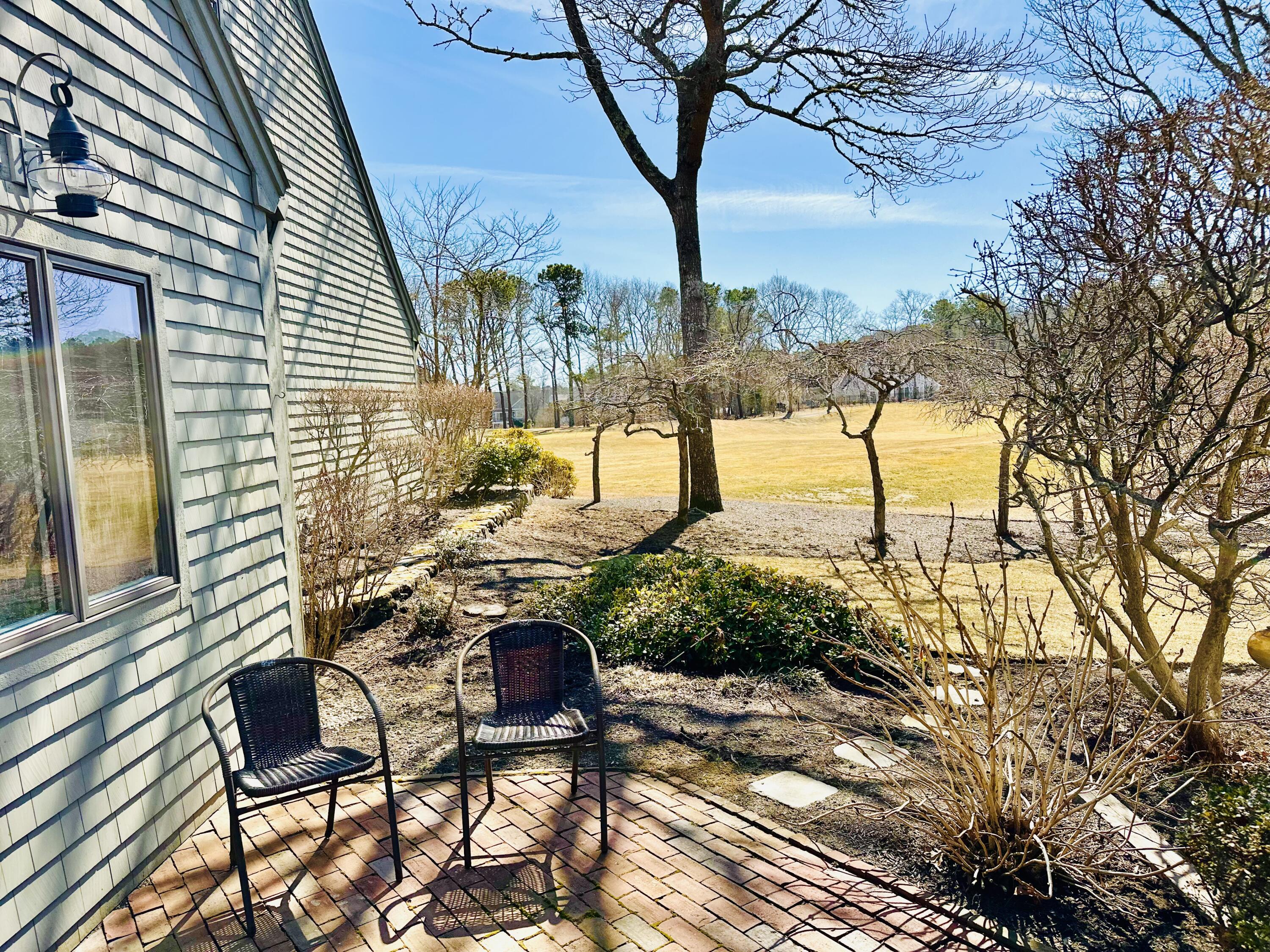 22 Mid-Iron Way, Unit 7517 Mashpee, MA 02649 - Photo 12 of 47 a view of a backyard with sitting area