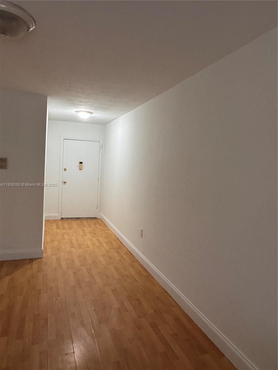 15888 Southwest 95th Avenue, Unit 201 Miami, FL 33157 - Photo 11 of 27 an empty room with wooden floor