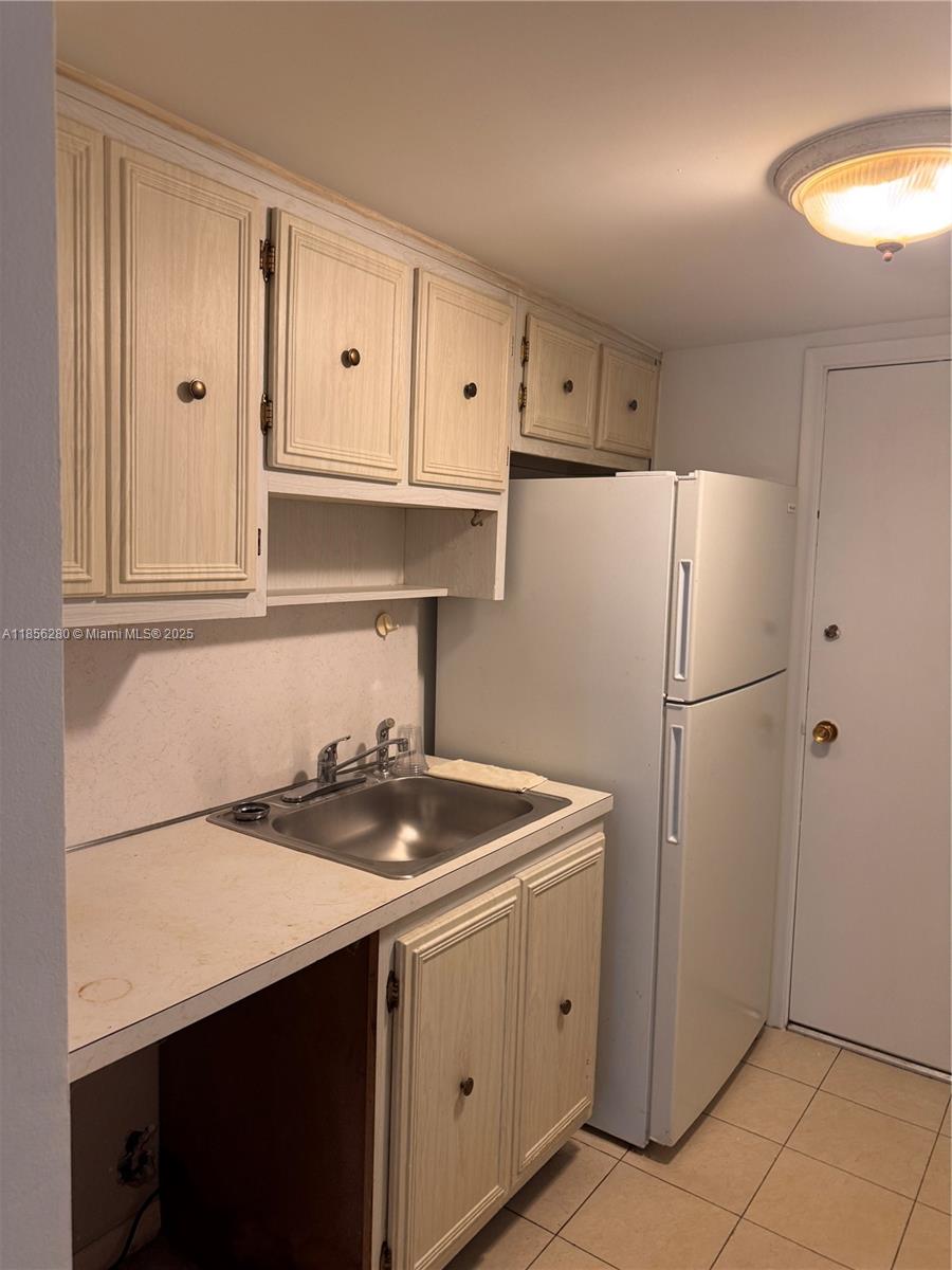 15888 Southwest 95th Avenue, Unit 201 Miami, FL 33157 - Photo 13 of 27 a kitchen with stainless steel appliances granite countertop white refrigerator stove a sink and dishwasher