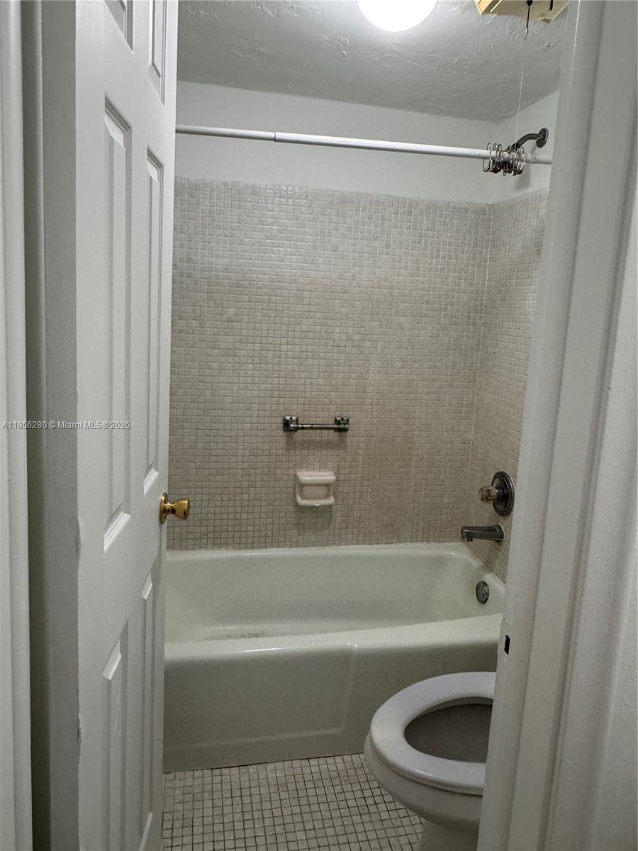 15888 Southwest 95th Avenue, Unit 201 Miami, FL 33157 - Photo 18 of 27 a bathroom with a shower a bathtub and a shower