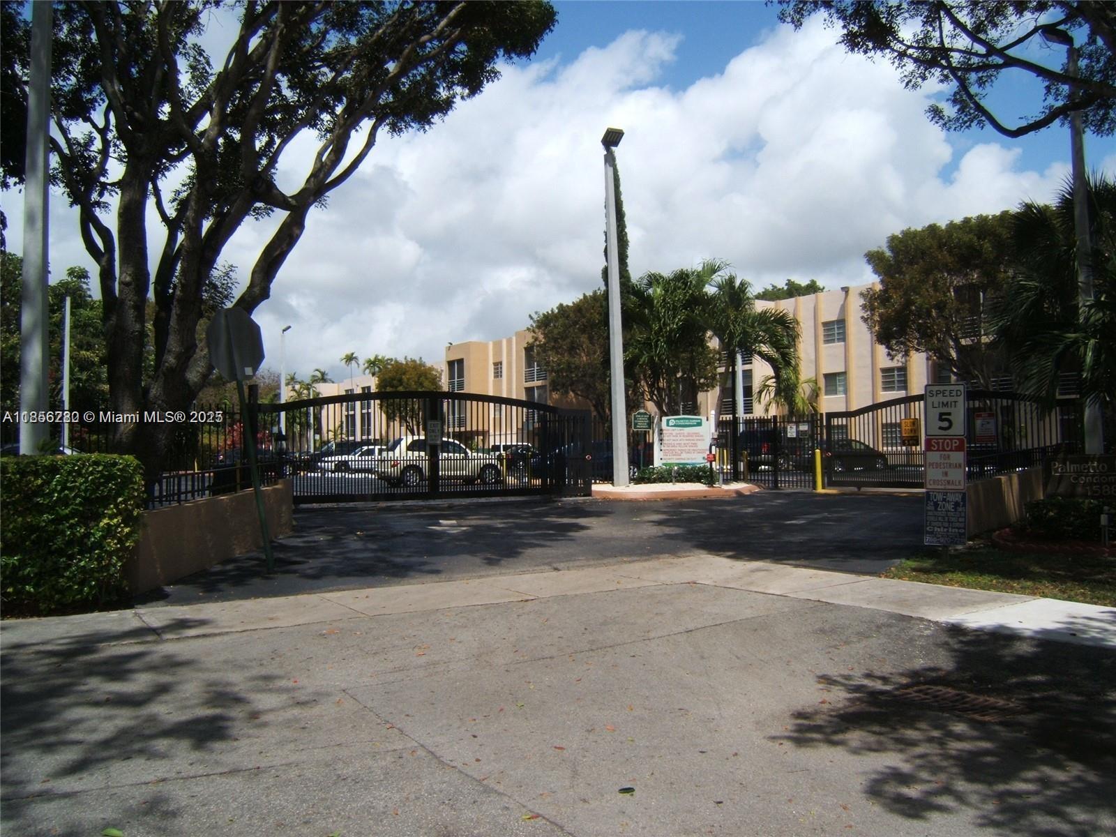 15888 Southwest 95th Avenue, Unit 201 Miami, FL 33157 - Photo 2 of 27 a view of a street with a cars on road